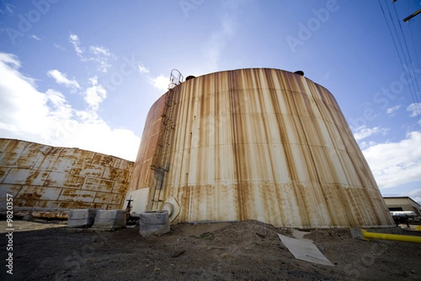Obraz Wide angle image of an old tank used to hold molasses.