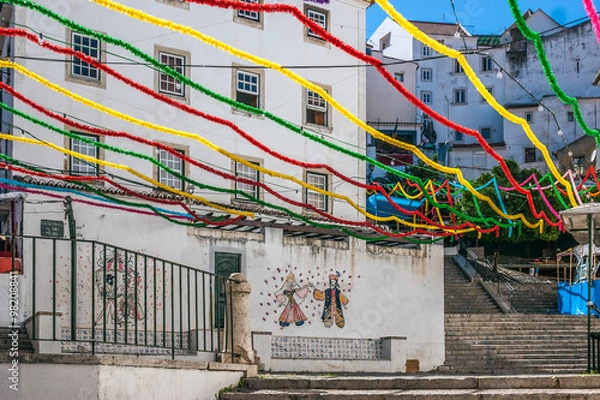 Fototapeta Stairs of San Miguel in Alfama neighborhood, adorned with many colors during the holidays of San Antonio. They are celebrated in the month of June in Lisbon, the capital of Portugal