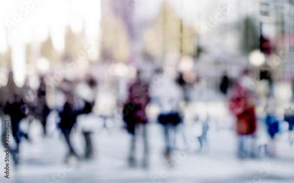 Fototapeta City commuters. High key blurred image of people walking in the
