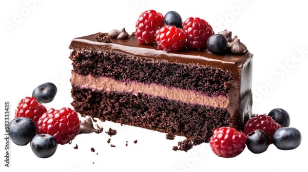 Fototapeta A delicious slice of chocolate cake topped with fresh berries and cream, presented on a white plate