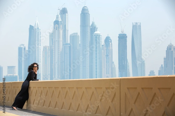 Fototapeta Woman on the background of skyscrapers
