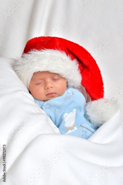 Obraz Kleines Baby ist am schlafen und trägt eine Weihnachtsmütze