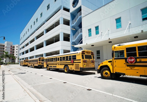 Obraz Three yellow school buses parked near the school in Miami, USA