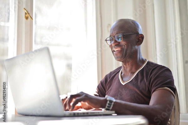 Fototapeta adult man works in a computer at home