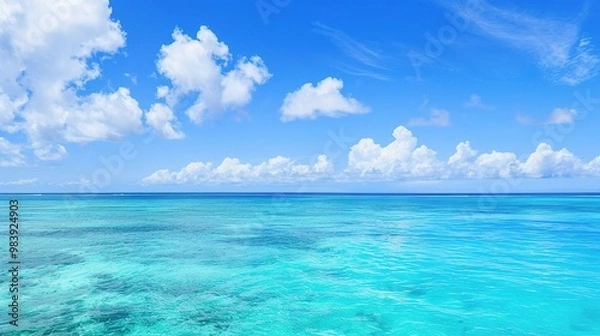 Fototapeta A beautiful scene of the blue ocean against the blue sky background. The ocean stretches out as far as the eye can see, with its surface glistening in the sunlight
