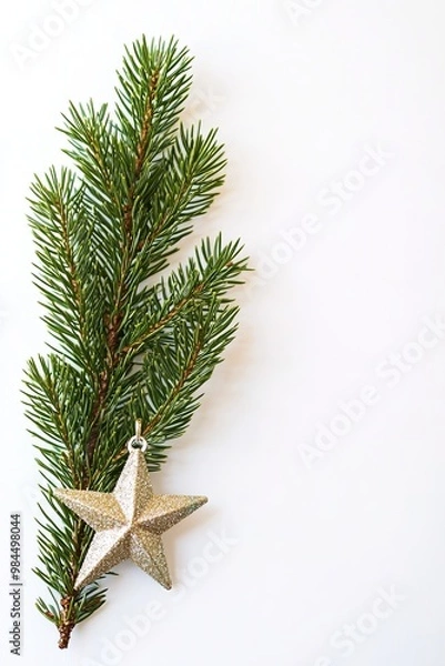 Fototapeta Pine branch with gold star on white background.