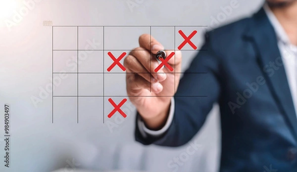 Fototapeta Businessperson marking a tic-tac-toe grid on a transparent surface.