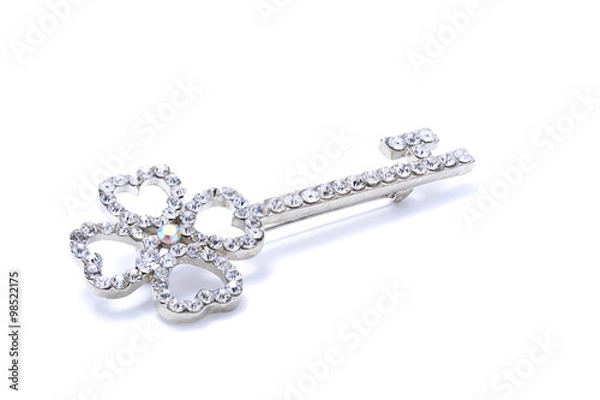 Fototapeta brooch in the form of a key on a white background