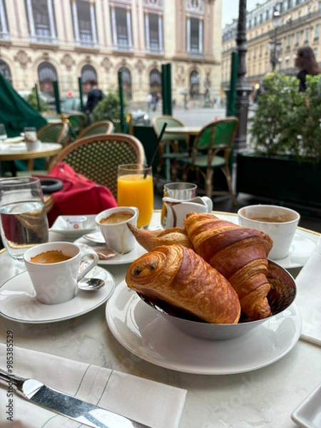 Fototapeta Pain au chocolate and croissant on table with coffee at the terrace with city view, elegant breakfast concept.  