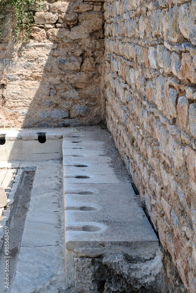 Fototapeta Ancient public Toilet bathroom seats on Ephesus , public toilets used in ancient times, sitting toilets side by side