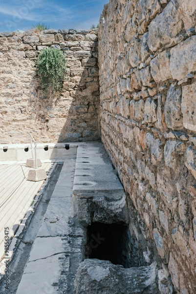 Fototapeta Ancient public Toilet bathroom seats on Ephesus , public toilets used in ancient times, sitting toilets side by side