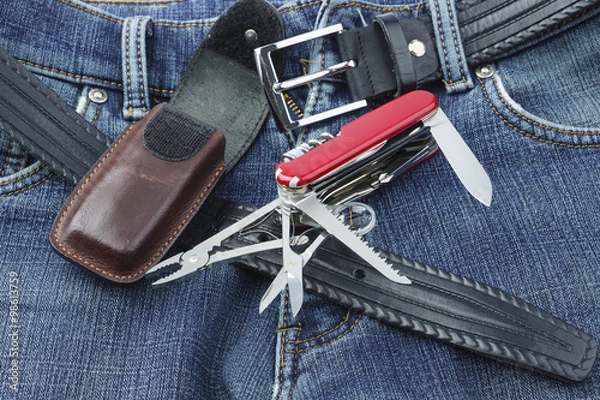 Fototapeta Blue jeans with multifunction penknife