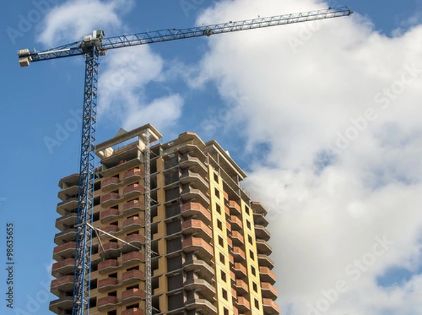 Obraz New high-rise building on the background of the cloudy sky