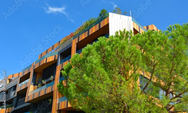 Fototapeta A modern mid rise apartment block in Nova Gorica, Slovenia.Built early 21st century with a striking colorful facade.Contemporary, eco-conscious architecture comprising modern materials & modern design