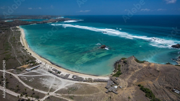 Fototapeta Kuta Beach is a sandy beach type that was formed as a result of wave erosion, sediment deposition, and organic material.,