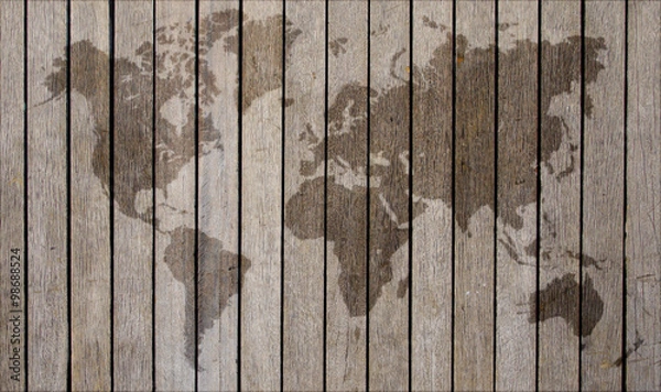 Obraz world map overlaid on brown wooden texture patterned background