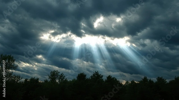 Fototapeta Golden Rays of Hope: Sunlight Breaking Through Dramatic Clouds in the Sky