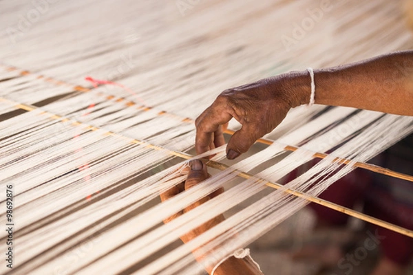 Obraz white silk thread in sewing or weaving machine,texture,backgroun