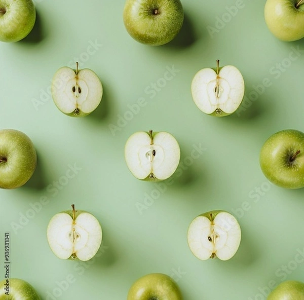 Fototapeta green apples pattern on pastel green background, copy space, apples cut in half, top view