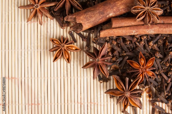 Fototapeta Spices for mulled wine on bamboo background