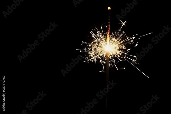 Fototapeta New Year sparkling fireworks in a clear night sky with festive atmosphere for holiday celebrations