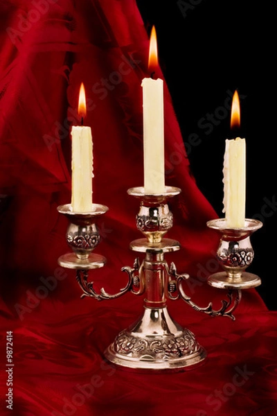 Fototapeta candlestick with three candles and reflection