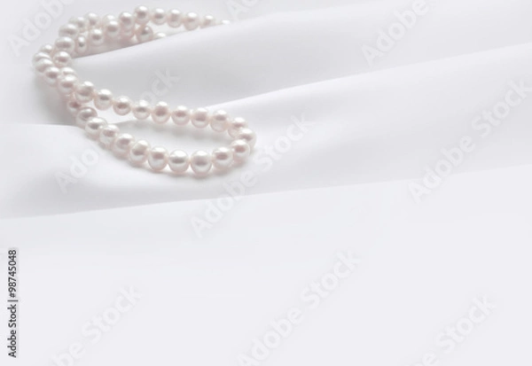 Fototapeta Elegant white background with silk and pearl