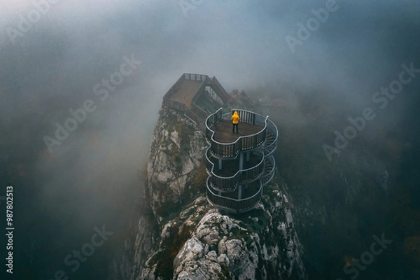 Fototapeta Valla Canyon. Valla Canyon stands in all its glory among the fog. A man in a yellow coat enjoys the view at the top of the canyon. Drone shot. Kastamonu, Turkey.