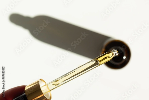 Fototapeta Closeup of a pipette with organic rosehip facial oil. 