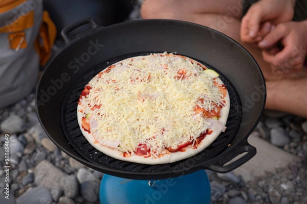 Obraz Pizza Prepared in a Wok. Campfire Pizza: Cooking Outdoors in Nature.