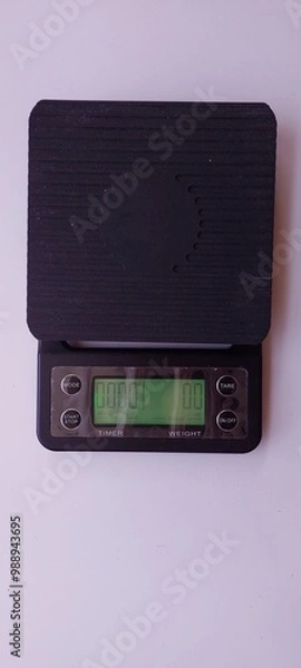 Fototapeta A small scale for measuring cake ingredients on a white background