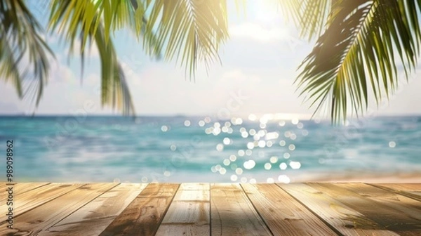 Fototapeta Wooden deck overlooking a tropical beach with palm leaves and ocean view. Summer vacation concept.