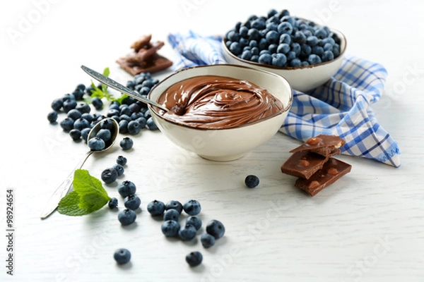 Fototapeta Beautiful composition with chocolate cream and blueberries