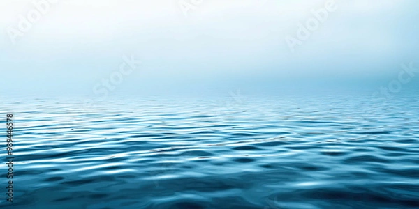 Fototapeta The image is of a calm body of water with a blue color