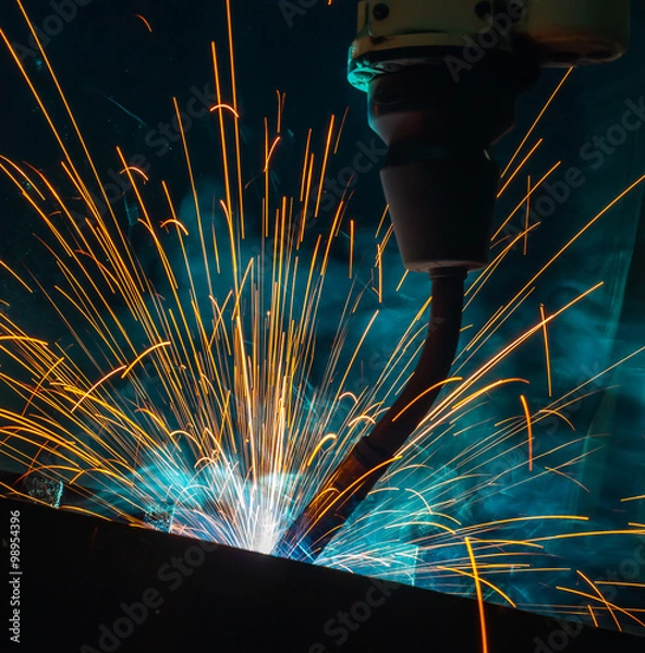 Obraz  welding robots movement in the automotive parts industry 