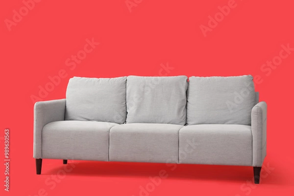 Obraz Grey sofa on red background