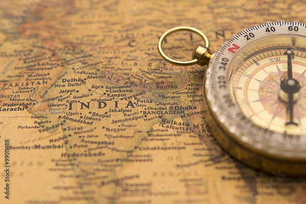 Obraz Old compass on vintage map selective focus on India
