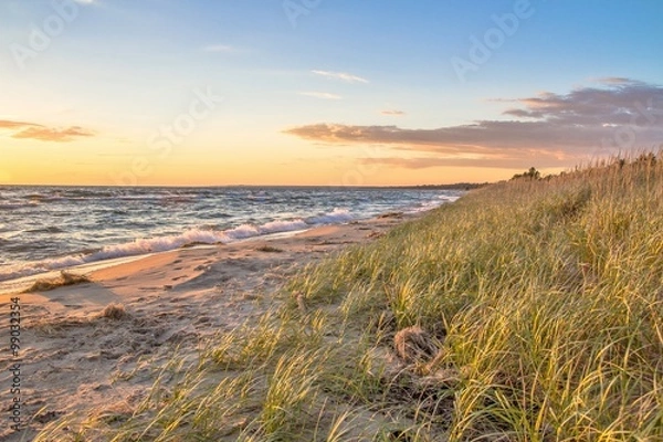 Obraz Summer Beach Background.  Remote beach bathed in golden light with sand dunes and dune grass. St. Ignace, Michigan.