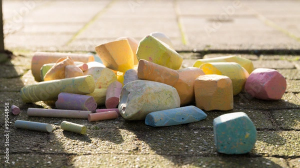 Obraz Sidewalk chalk piled up. lighted bij the sun.
