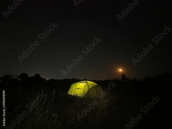 Fototapeta Illuminated tent under night starry sky with moon