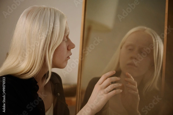 Obraz Medium closeup of mysterious young Caucasian woman with albinism looking in mirror and touching her reflection