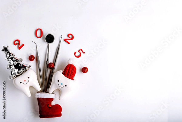 Fototapeta Tooth figurines and dental tool for christmas and new year 2025, top view. holiday medical concept