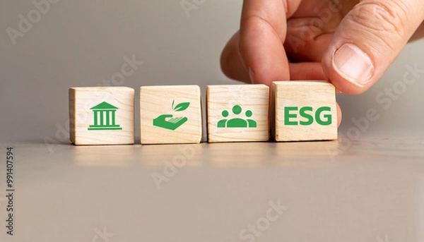 Fototapeta ESG Concept with Wooden Cubes Displaying Environmental, Social, and Governance Icons, Hand Arranging Sustainability Symbols for Corporate Responsibility and Ethical Business Practices.