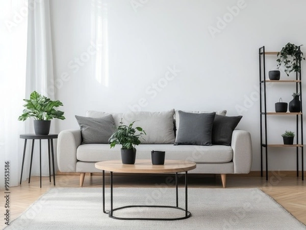 Fototapeta A living room with clean white walls, a neutral grey sofa, and a light wood coffee table