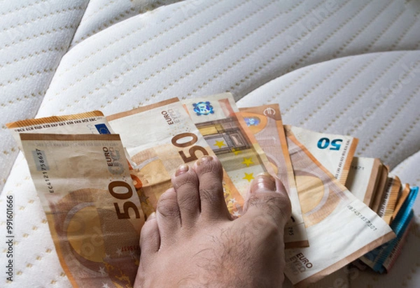 Fototapeta European banknotes with a foot on a white mattress
