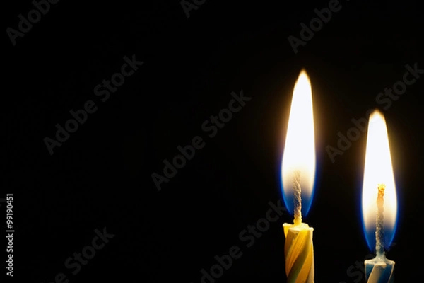 Obraz burning candle isolated on black 