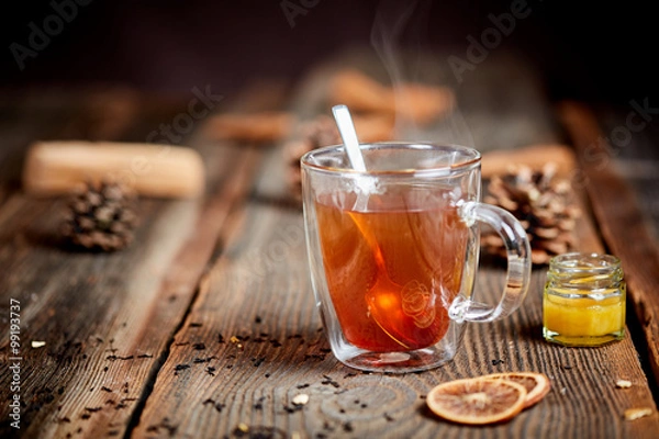 Fototapeta Steaming tea and honey on a wooden table