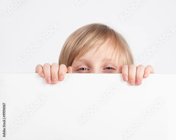 Fototapeta Boy hiding behind a white poster