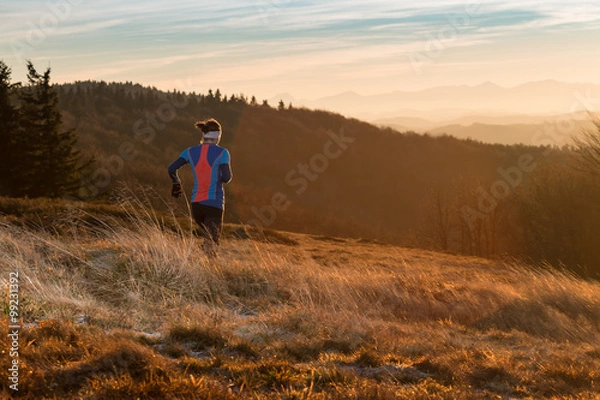 Obraz woman running alone in the mountains in the morning