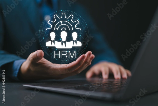 Fototapeta HRM, human resources management, businessman using laptop with HRM icon on virtual screen. Human development recruitment leadership and customer target concept.